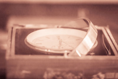 Close-up of old clock on table