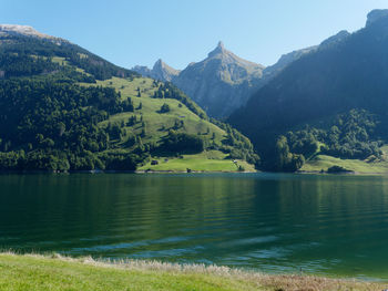 Scenic view of lake and mountains against sky