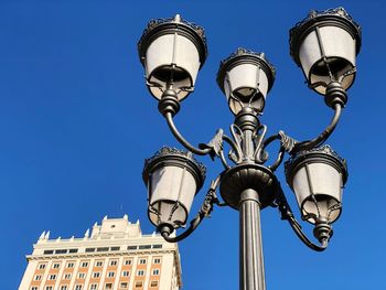 Low angle view of street light against building