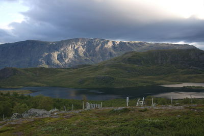 Scenic view of lake and mountains against sky