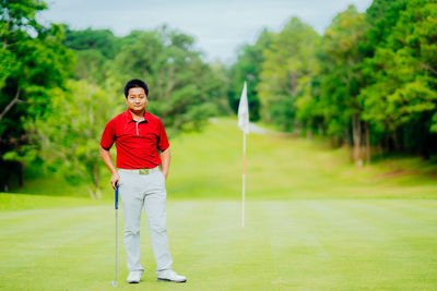 Portrait of man standing on golf course