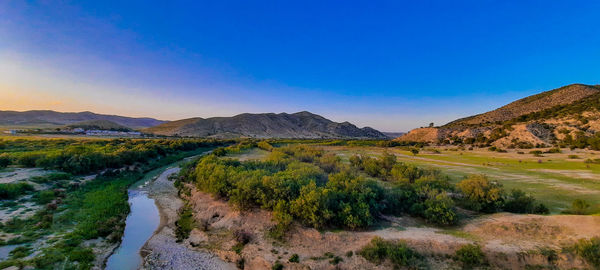 Scenic view of mountains against clear blue sky