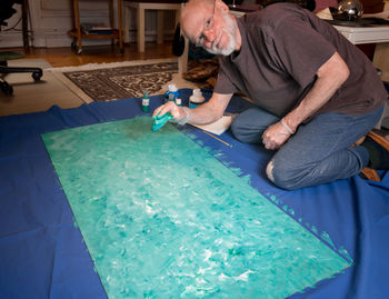 Portrait of senior man painting at workshop