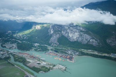 High angle view of lake and mountains against sky