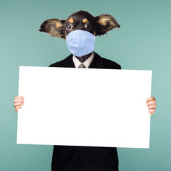 Digital composite image of man holding paper against blue background