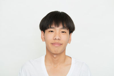 Portrait of smiling man against white background