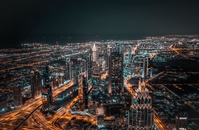 High angle view of illuminated buildings in city at night