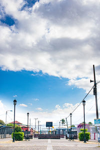 Street by train against sky in city
