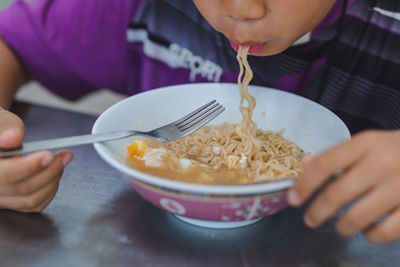 Midsection of man eating food