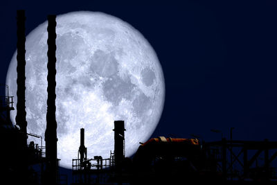 Low angle view of silhouette moon against sky at night