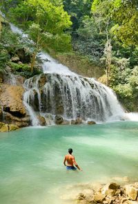 Full length of shirtless man in water