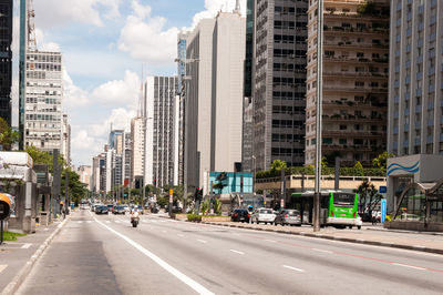 City street by buildings against sky