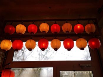 Low angle view of illuminated lanterns hanging at night