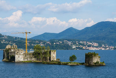 Scenic view of sea and buildings against sky