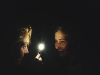 Silhouette of woman in dark room