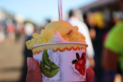 Close-up of hand holding ice cream cone