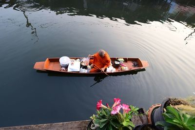 High angle view of people sitting on lake