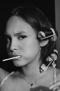 Portrait of teenage girl eating lollipop while standing outdoors