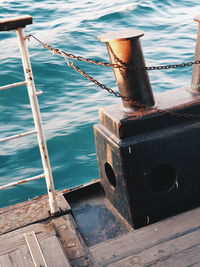 High angle view of rope tied to bollard