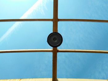 Pendant light hanging from ceiling against sky