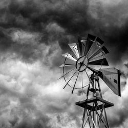 Low angle view of traditional windmill against sky