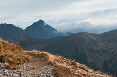 Scenic view of mountains against cloudy sky