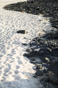 High angle view of footprints on snow covered land