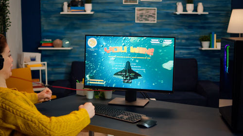 High angle view of man and woman using laptop on table