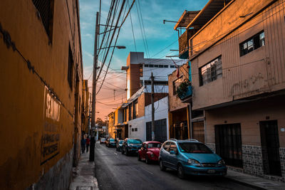 Cars on street amidst buildings in city