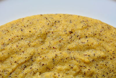 Close-up of bread in plate against white background