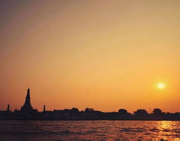 Temple viewed from riverside at sunset