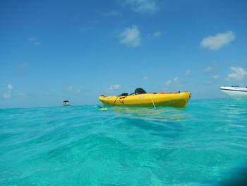 Boat in sea against blue sky