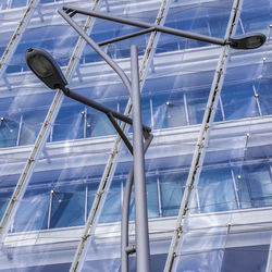 Low angle view of street lights against modern building