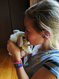 High angle view of girl kissing bunny