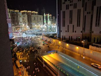 High angle view of illuminated city street and buildings at night