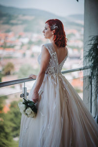 Woman standing on white wall