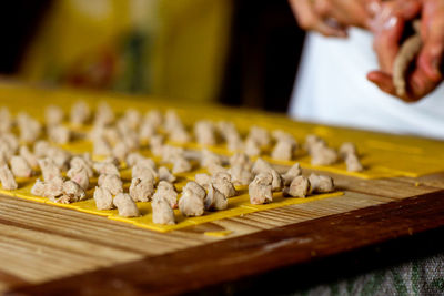 Close-up of person preparing food on table