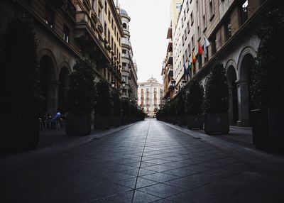 Narrow street amidst buildings in city