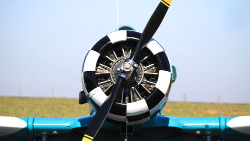 Airplane on field against clear sky