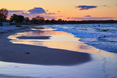 Scenic view of beach against sky during sunset