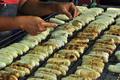 Midsection of man preparing food at market