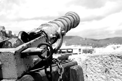 Close-up of metal chain against sky