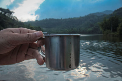 Person holding glass of water