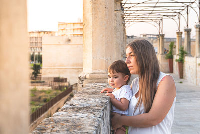 Mother and daughter while standing outdoors