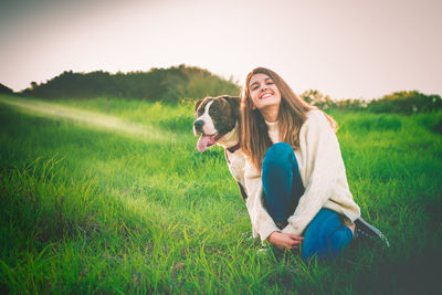 Woman with dog on field