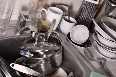 Close-up of utensils in sink at kitchen