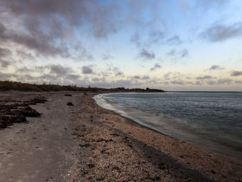 Scenic view of beach against sky during sunset