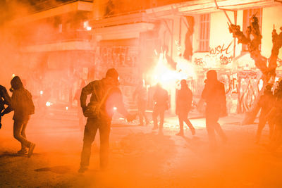 Group of people in front of building at night