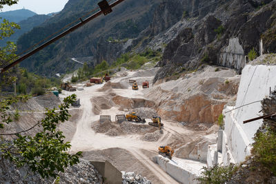 View of the carrara marble quarries with excavation vehicles ready for work.