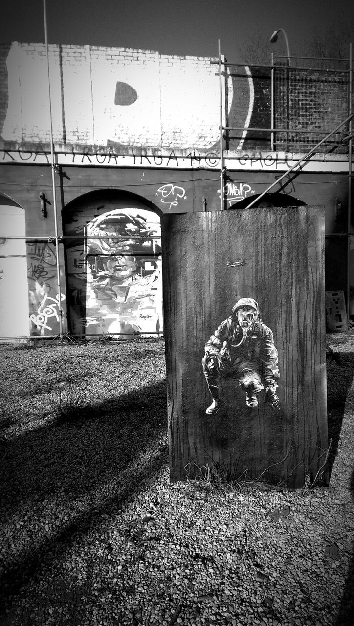 built structure, architecture, transportation, connection, day, no people, arch, outdoors, sunlight, bridge - man made structure, mode of transport, abandoned, metal, field, grass, building exterior, text, old, sky, absence